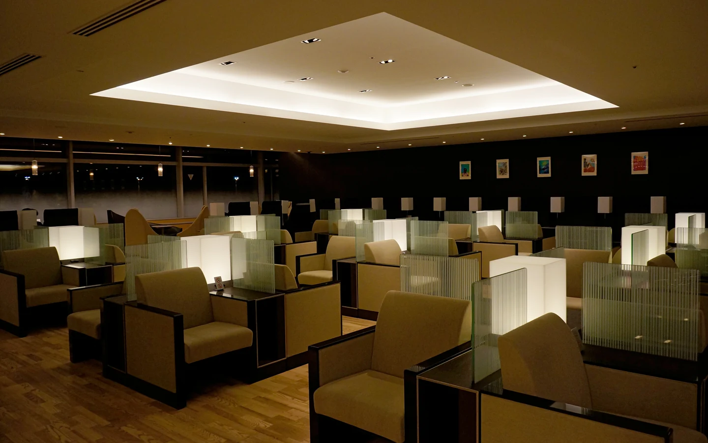 Warmly lit ANA Lounge seating area at Tokyo Haneda domestic terminal