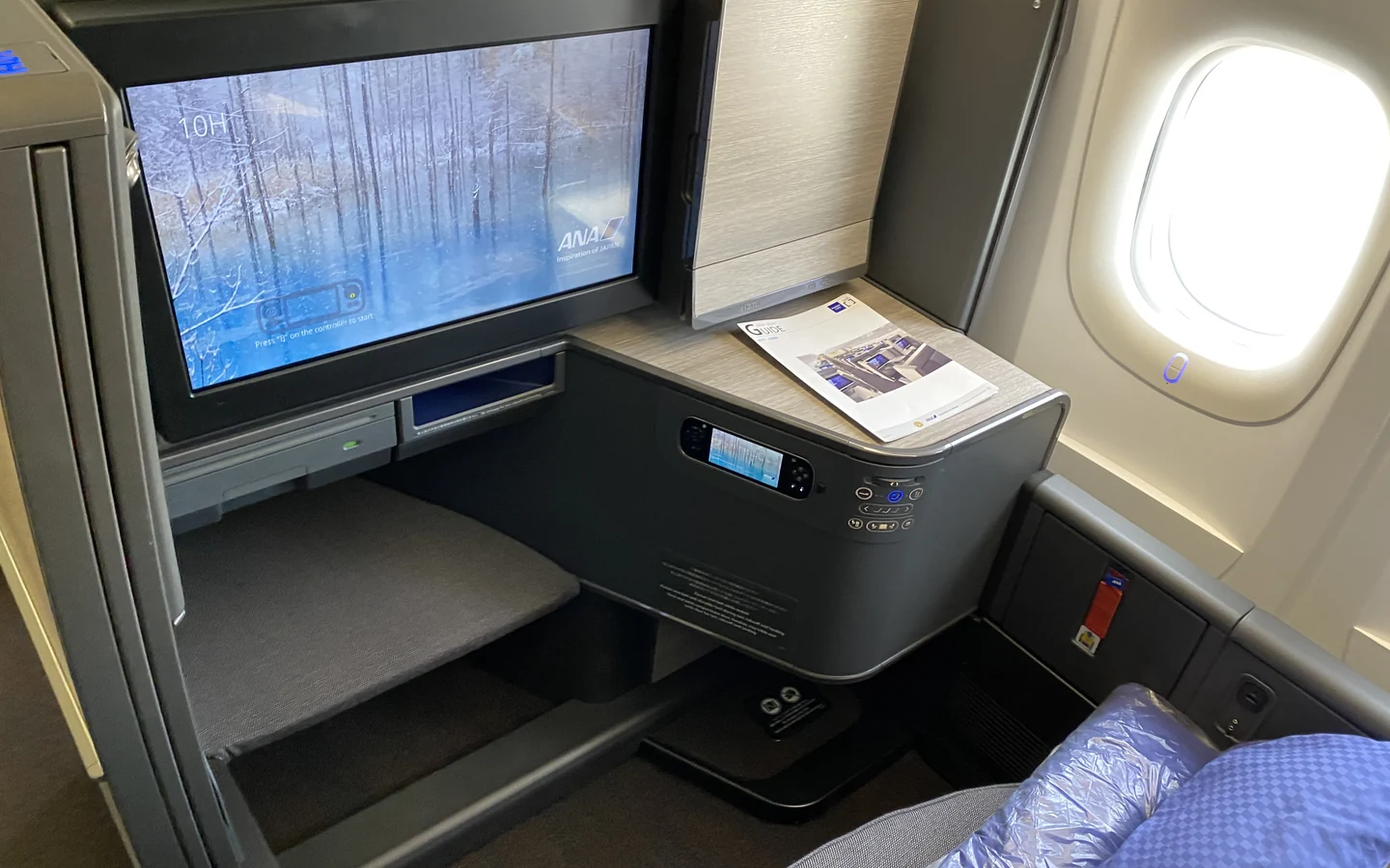 ANA THE Room business class suite with a large entertainment screen and window-side console