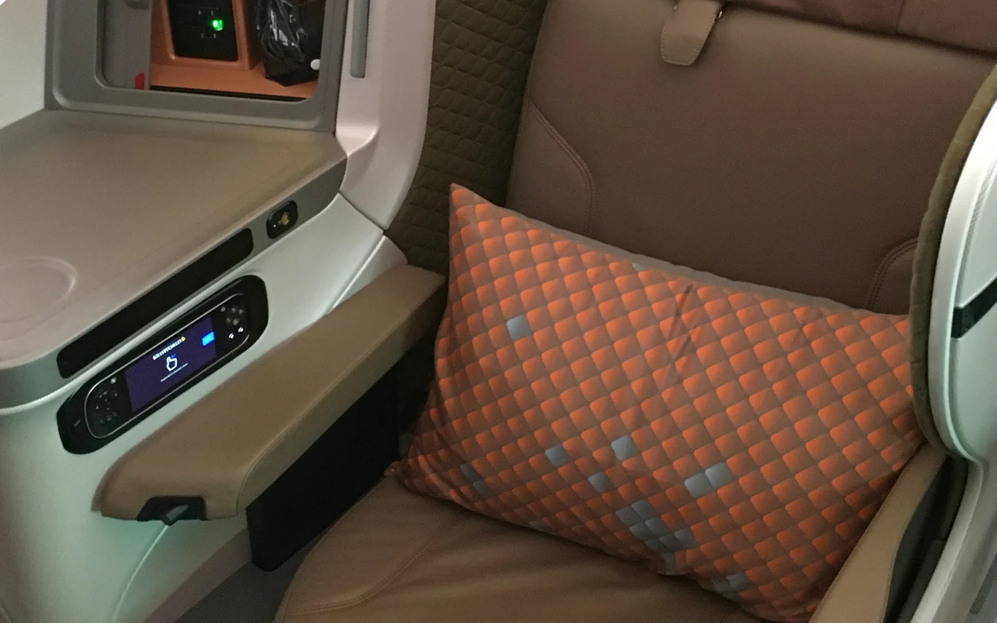 Singapore Airlines Boeing 787-10 regional business class seat with stitched leather and an orange cushion