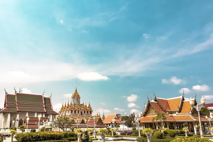 Loha Prasat temple complex in Bangkok beneath a blue sky