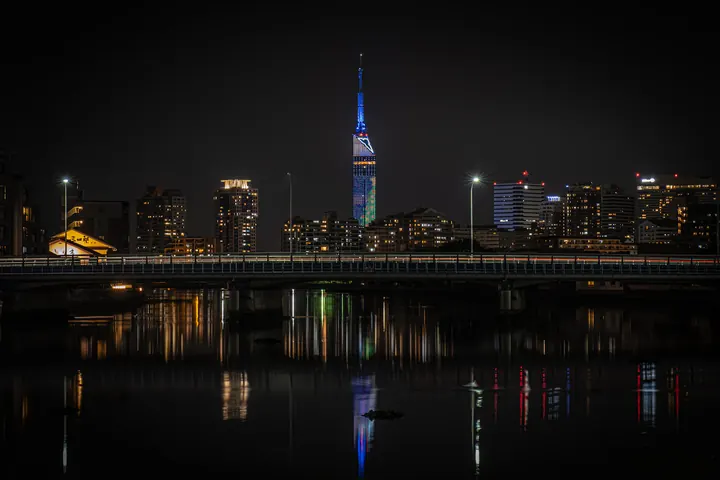 Fukuoka Tower and waterfront buildings reflected in the river at night