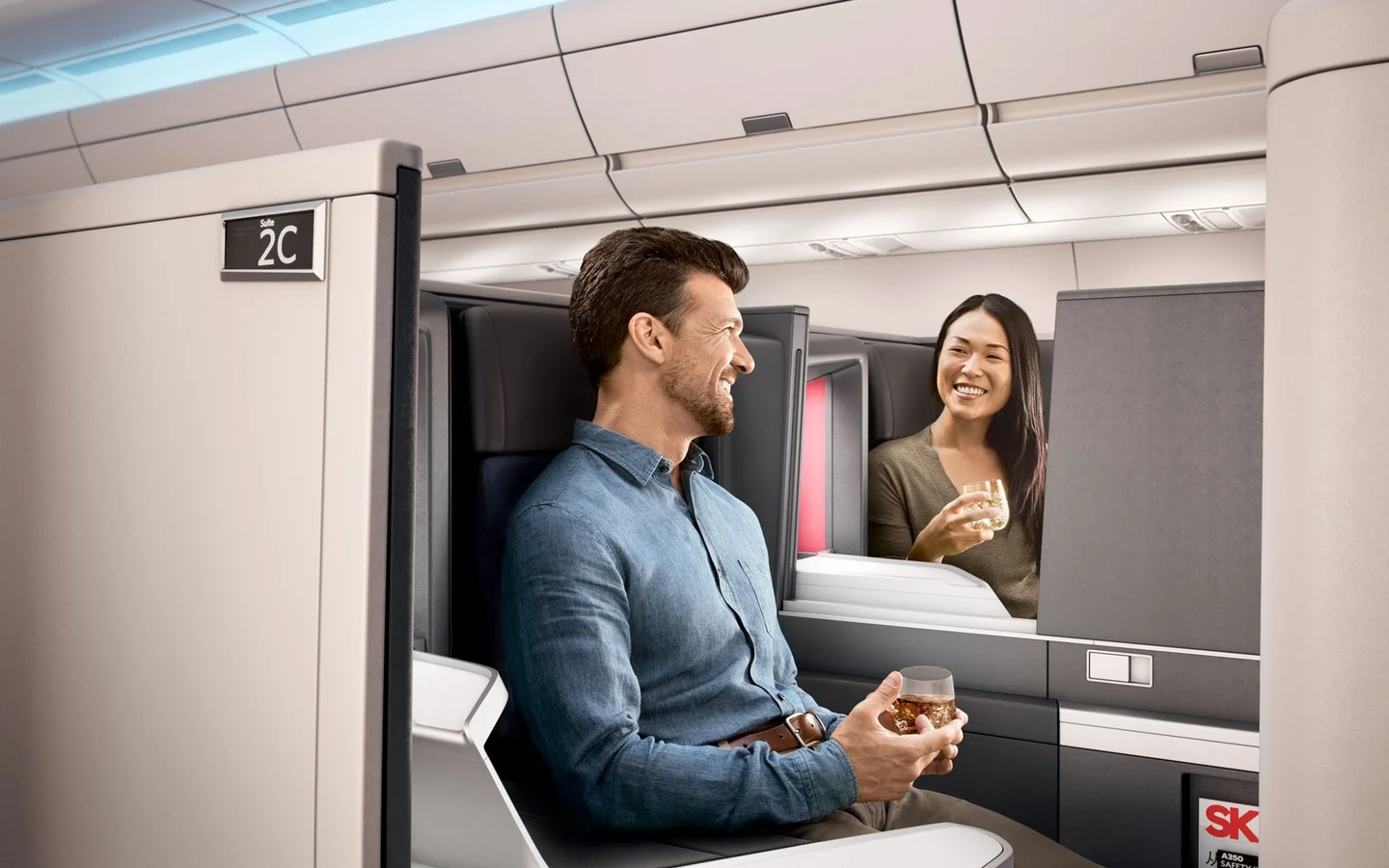 Travelers seated in Delta One suites